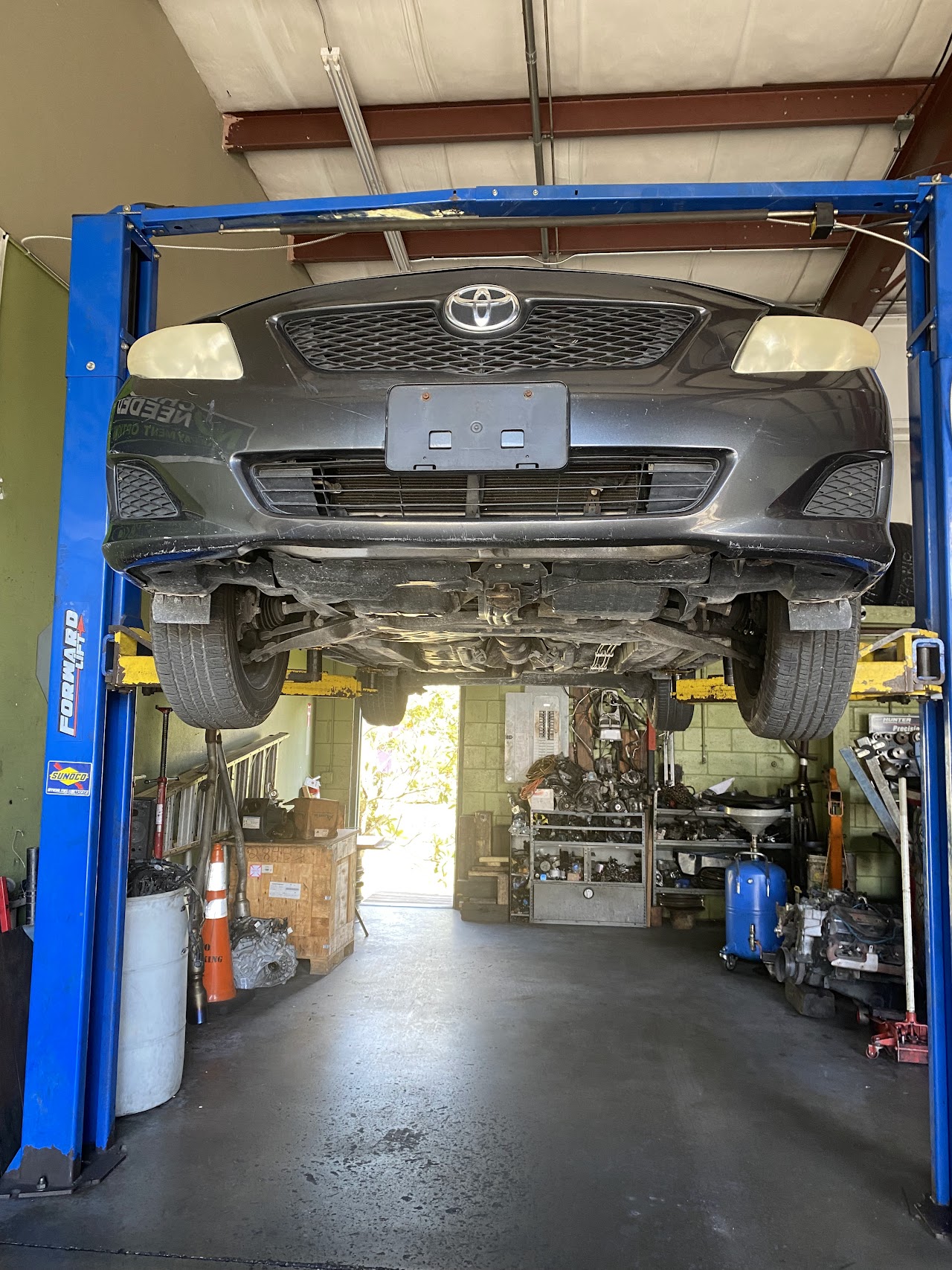 Fercho Auto Repair workshop in Kissimmee with car on hydraulic lift